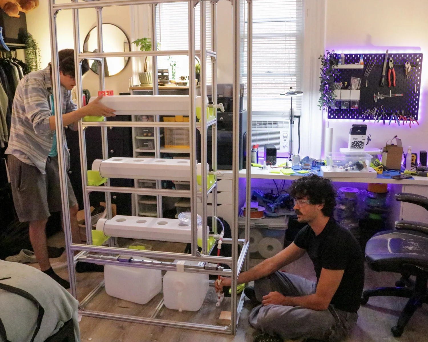 Plant Wizard team members assembling the growing channels, frame, and plumbing.