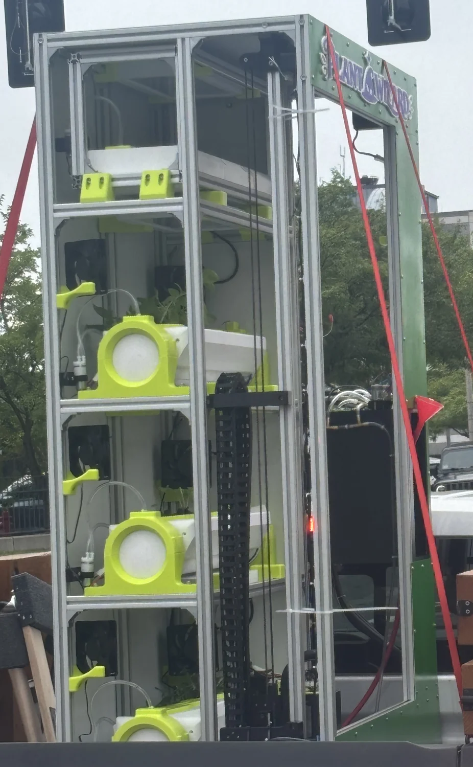 The assembled Plant Wizard prototype with green channel mounts, plumbing, enclosure panels, and a vertical gantry.